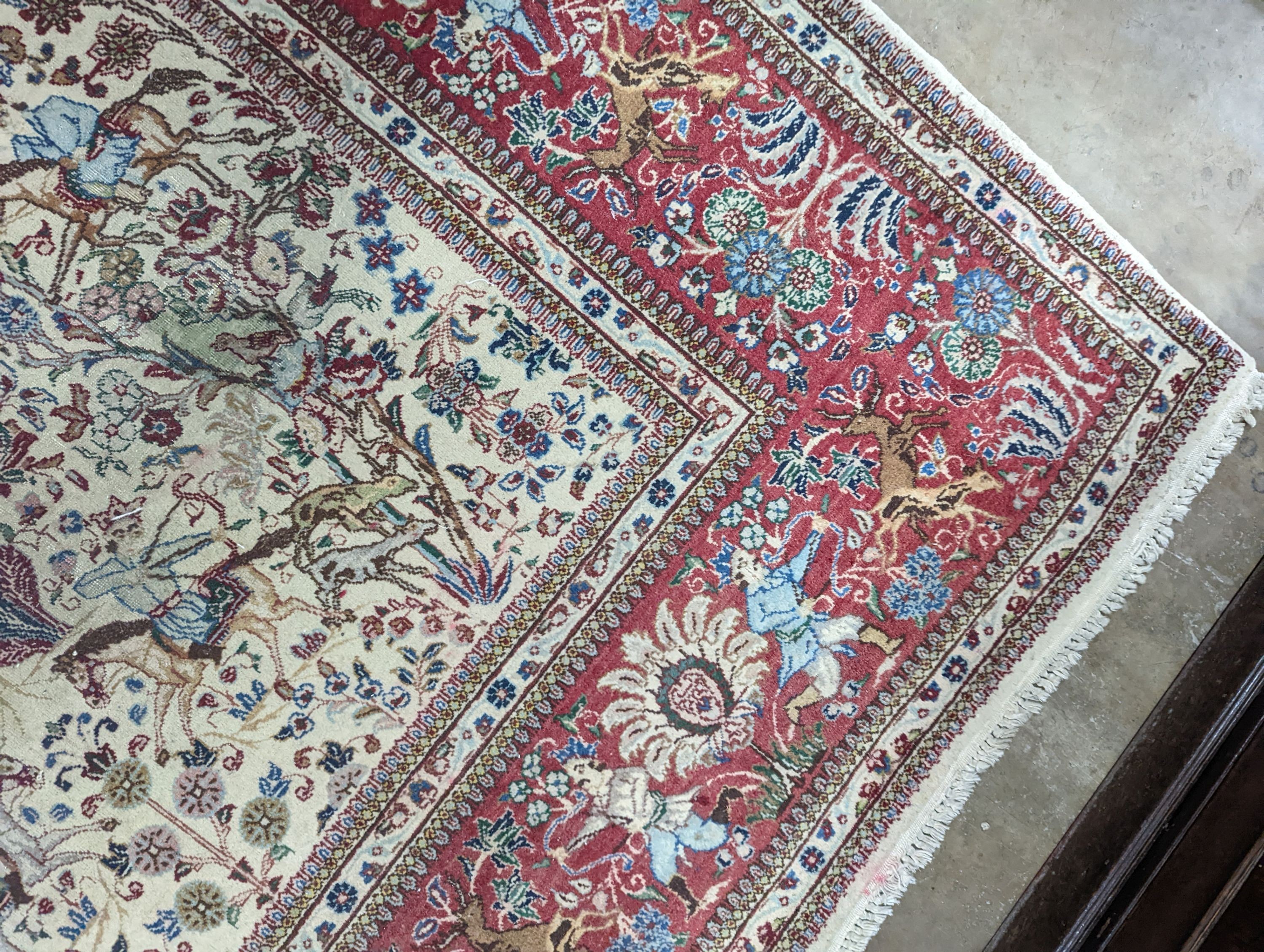 A Tabriz ivory ground pictorial rug (signed), 390 x 294cm